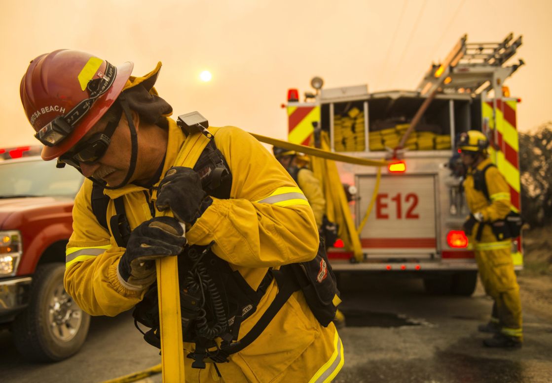Firefighters move equipment to battle a fire in Lancaster, California, on June 2.