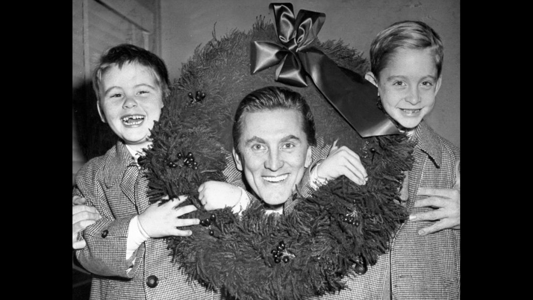 His father, actor Kirk Douglas, sits with his brother, Joel and Michael, at then-Idlewild Airport, in 1955. Michael is the eldest son. 