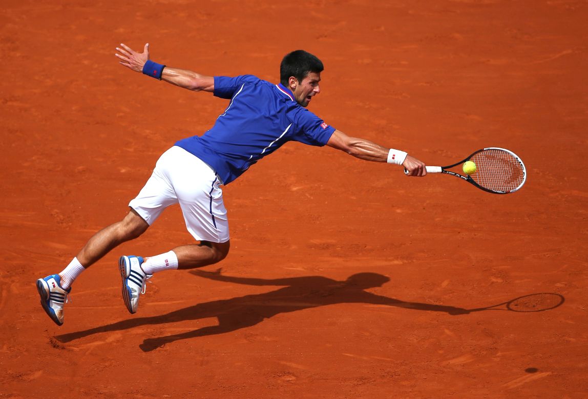 Serbia's Novak Djokovic dives for a backhand during his match against Germany's Philipp Kohlschreiber on June 3.