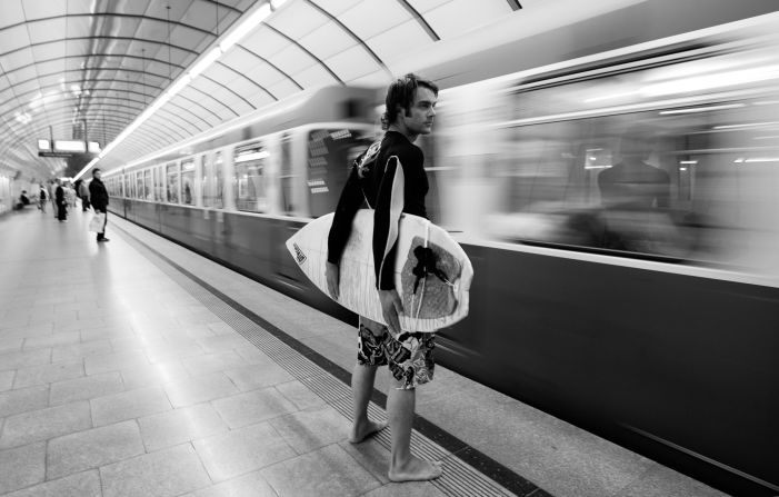 Here, surfer Alex Foerderer waits for a train to Eisbach. It was illegal to surf the icy brook until 2010, when the city of Munich allowed experienced surfers to ride the one-meter waves.