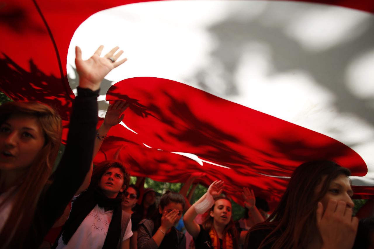 Despite Turkish Prime Minister Recep Tayyip Erdogan's call for calm on Monday, June 3, protests continued in Istanbul. Protesters carry the Turkish flag and shout against the government in Gezi Park near central Istanbul.