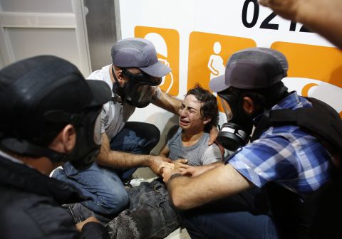 Police officers tend to a demonstrator during the violent clashes in Istanbul on June 3.