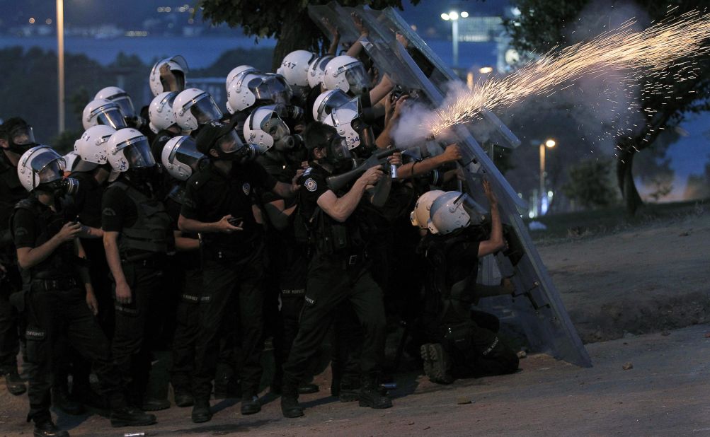 Turkish riot police fire tear gas canisters to disperse protesters near Taksim Square on June 3.
