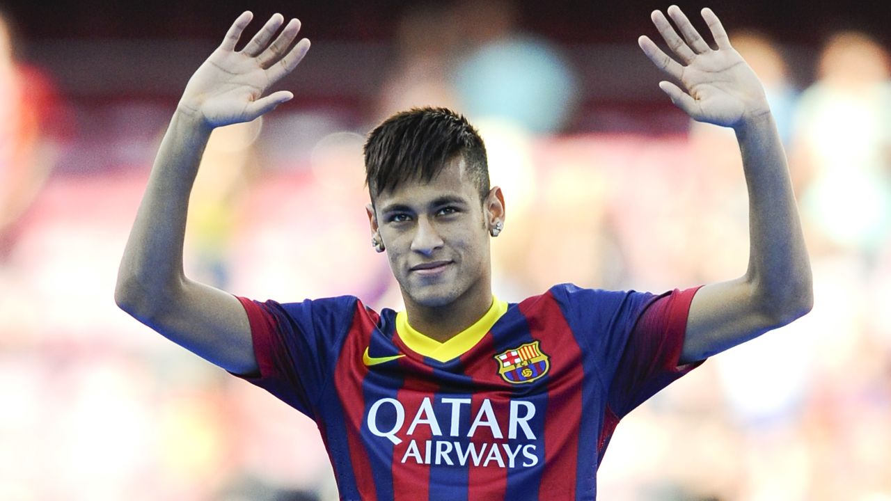 Neymar waves to a packed Nou Camp on the day he officially became a Barcelona player