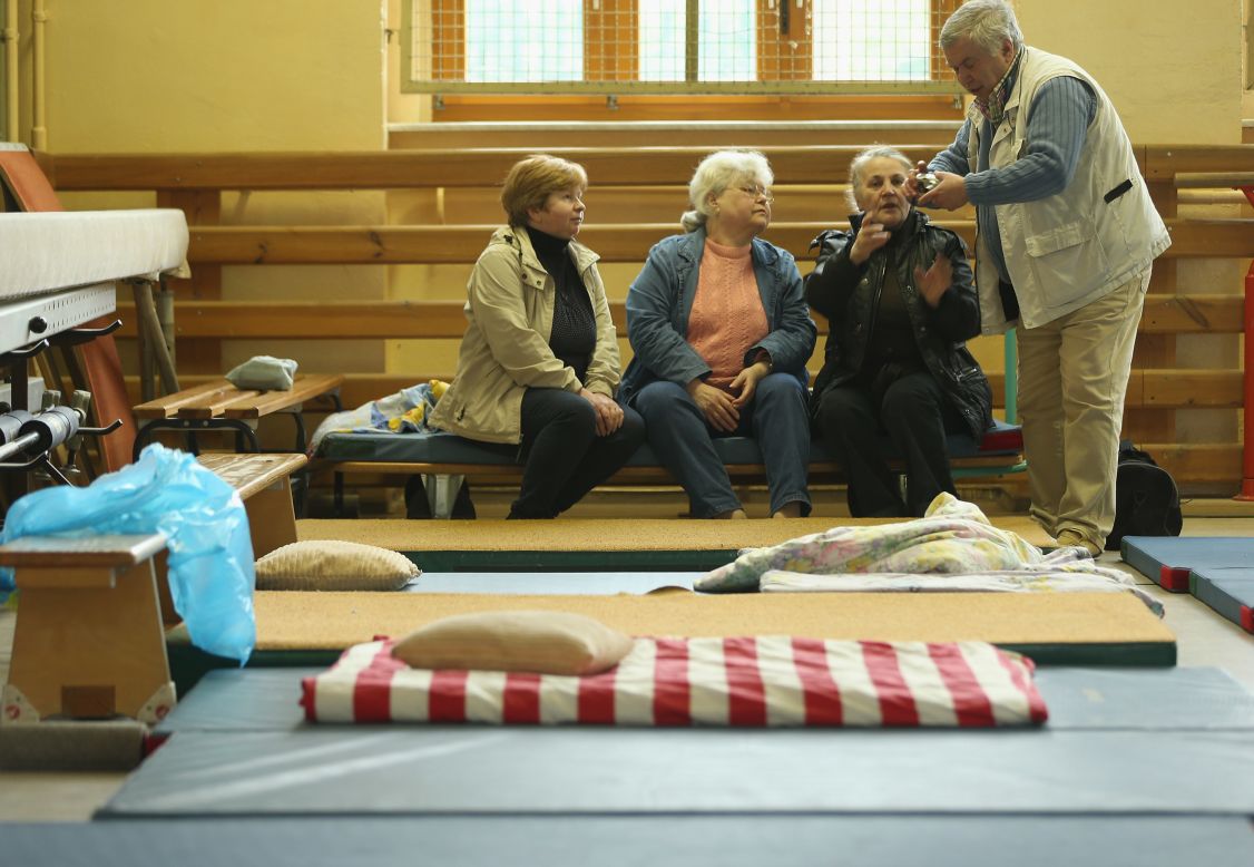 Evacuees  forced to flee the rising floodwaters of the Weisse Elster River sit on mattresses at an evacuation center in a school gymnasium in Zeitz, Germany, on June 3.