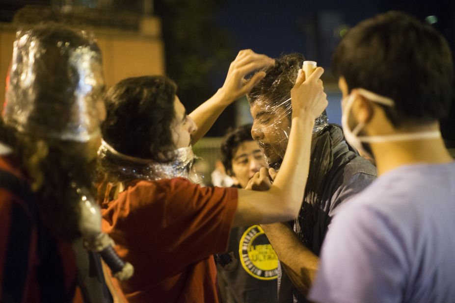 Protesters cover their faces with plastic. After chaotic scenes in the streets Monday that continued late into the night and sent tear gas wafting through the air, the situation was relatively calm on Tuesday morning in Istanbul's central Taksim Square, near the park where the movement began.