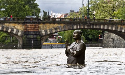 A statue by British sculptor Kaivalya Torpy depicting Indian spiritual leader Sri Chinmoy is partially submerged by the rising waters of the Vltava River on June 2 in downtown Prague.