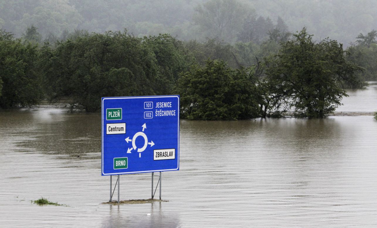 A traffic sign is surrounded by the flooded Berounka River on the outskirts of Prague on June 3.