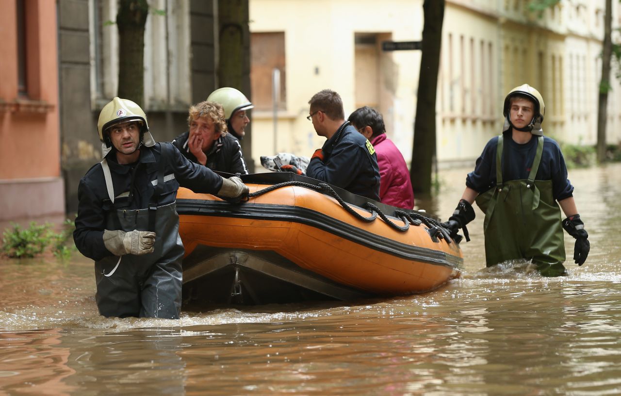 Firefighters evacuate local residents in Zeitz, Germany, on June 3 from a street flooded the night before by the nearby Weisse Elster River.
