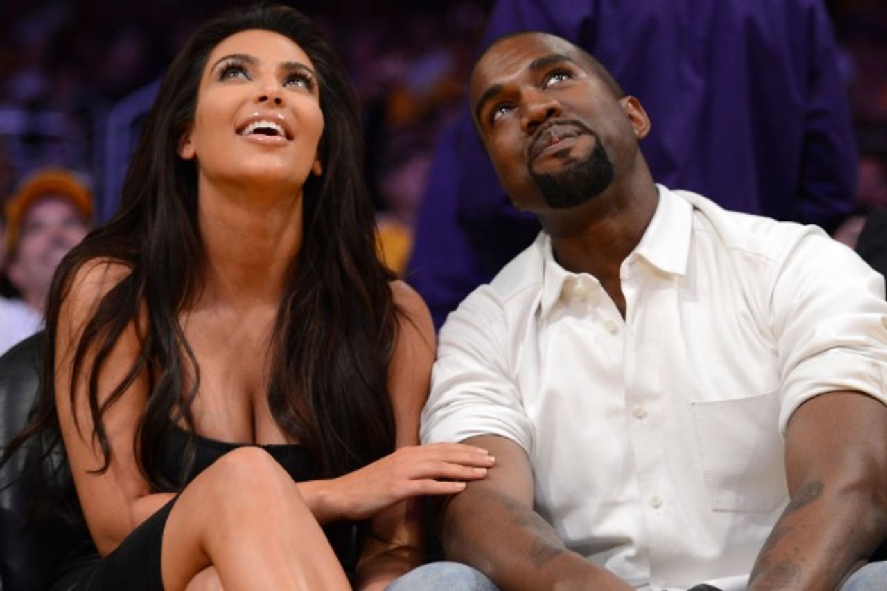 Kim Kardashian and Kanye West sit courtside at a Los Angeles Lakers game.