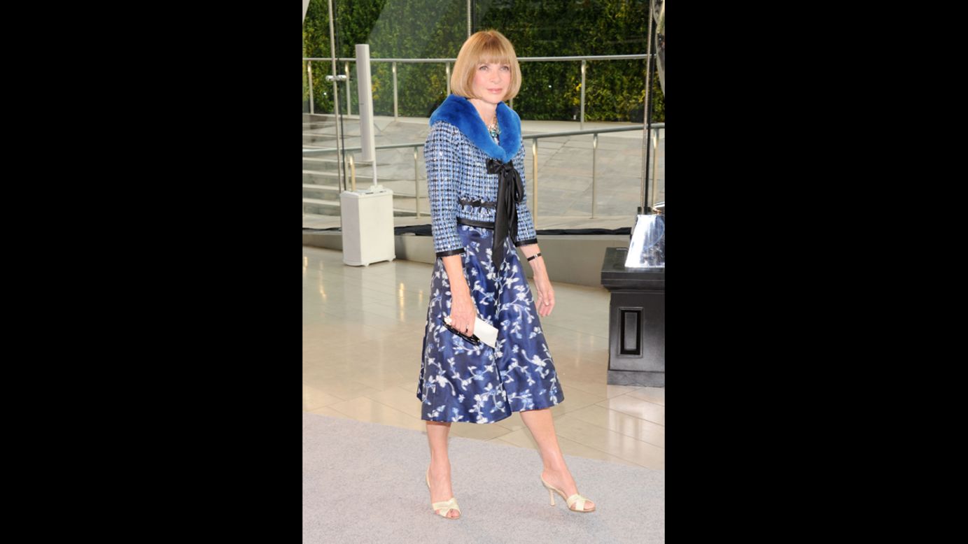 Vogue editor Anna Wintour tops a blue dress with a classic Chanel-silhouette jacket, just as Oscar de la Renta <a href="http://www.wwd.com/fashion-news/fashion-features/bridget-foleys-diary-an-oscar-moment-at-the-cfda-6962232?module=hp-hero-topstories" target="_blank" target="_blank">predicted she would</a> to Women's Wear Daily. 