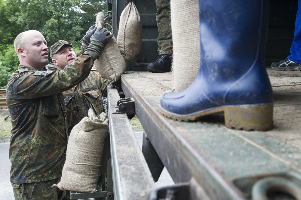 Volunteers and soldiers stack sandbags on June 4 to strengthen a dam of the rising Saale River on the outskirts in Halle, Germany.