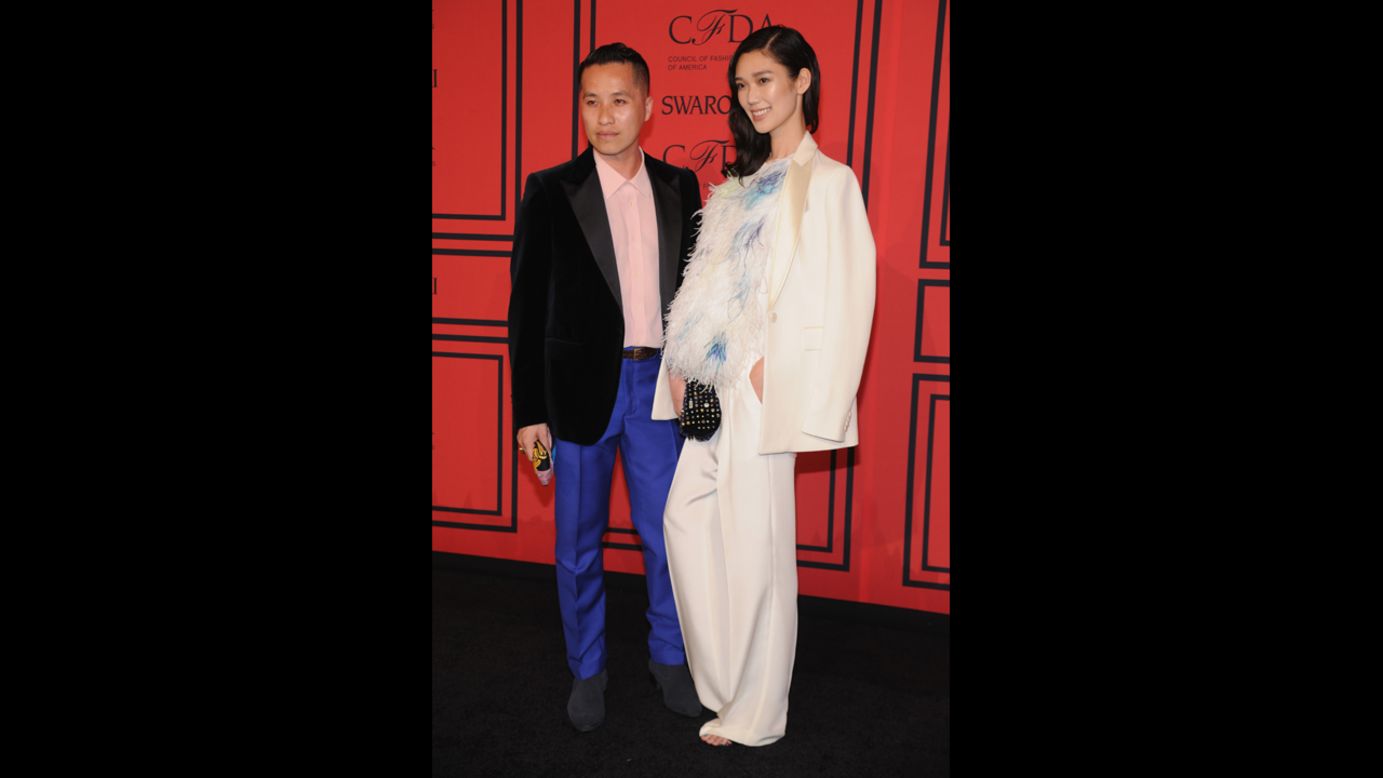 <a href="http://cfda.com/members#!phillip-lim" target="_blank" target="_blank">Phillip Lim</a>, winner of the Accessories Designer of the Year award, arrives at the ceremony with <a href="http://www.fashionologie.com/Models-Celebrities-Designers-CFDA-Awards-2013-30698431?slide=27&image_nid=30698447" target="_blank" target="_blank">model Tao Okamoto</a>.