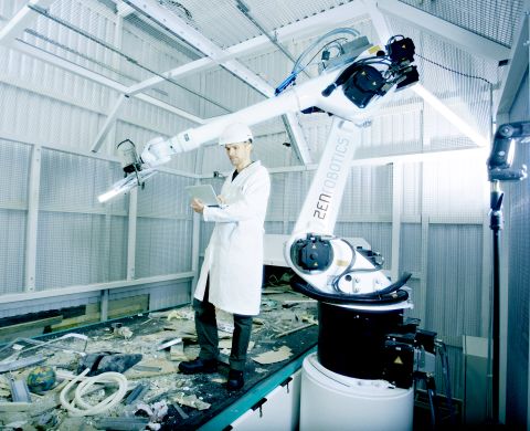 ZenRobotics Principal Scientist, Dr. Harri Valpola adjusts the robot of the ZRR system.