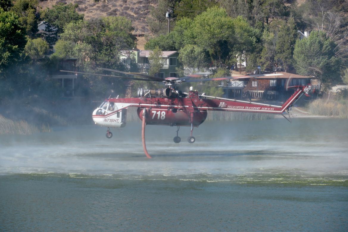 A helicopter fills up from Lake Hughes to battle the Powerhouse wildfire on June 3 in Palmdale.