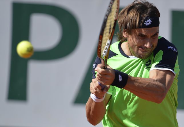 Ferrer plays a return to Robredo during the quarter final match.