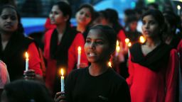 Members of India's 'Red Brigade' take part in a candlelight protest in Lucknow on May 7, 2013.
