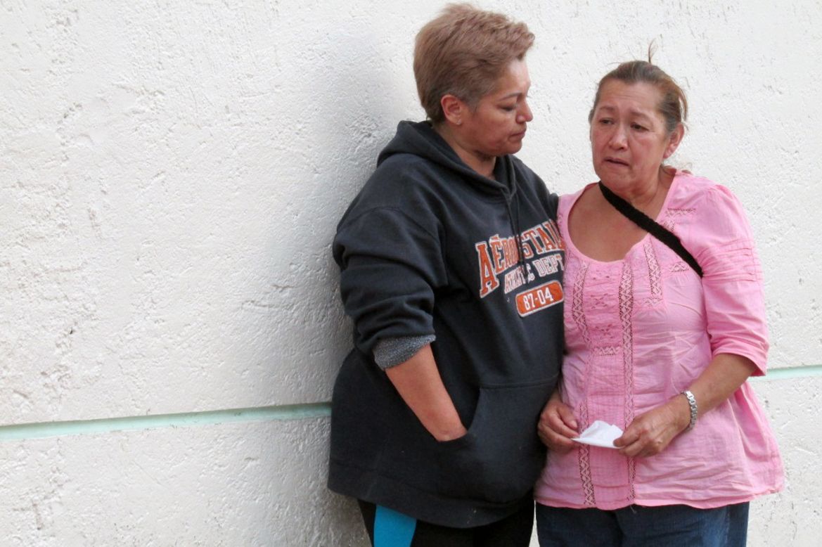 Maria Teresa Ramos, right, the grandmother of Jerzy Ortiz Ponce, is consoled by a neighbor in Mexico City on May 31.