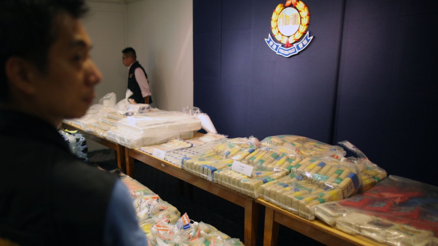 A policeman guards a selection of confiscated cocaine from one of the largest hauls in Hong Kong history on September 18, 2011. 