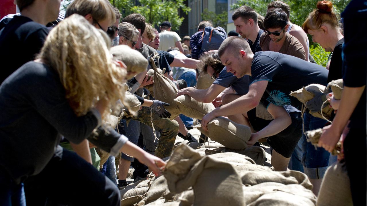 Residents transport sandbags to build a flood wall in a street flooded by the Elbe River in Dresden, Germany, on June 5.