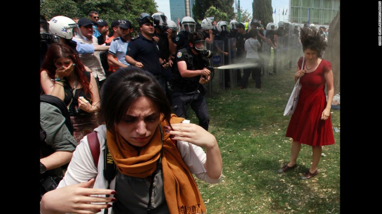 Turkish riot police spray a woman in Taksim Square with pepper spray on May 28, 2013. The <a href="http://www.cnn.com/2013/06/05/world/meast/turkey-woman-in-red/index.html">woman in a red dress</a> became an icon of the violent protests in Turkey, making international headlines and spreading across social media.