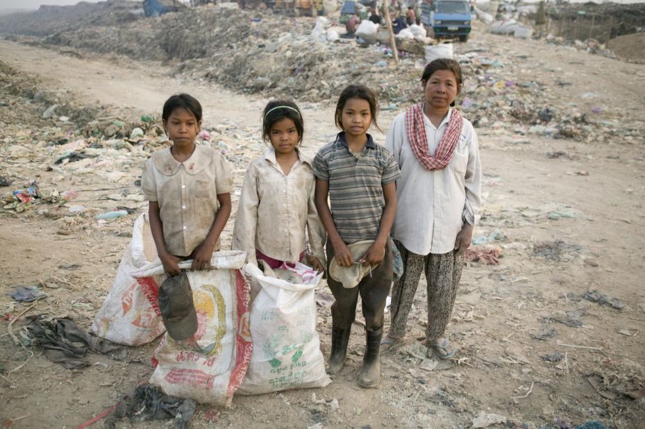 Sreyna stands next to her mother and two other girls. The Smiths made a deal with the girls' mother to pay her what her daughters would make at the dump in exchange for sending the girls to school.  