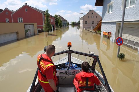 German Lifesaving Society workers drive through the flooded area of Deggendorf, Germany, on June 5.