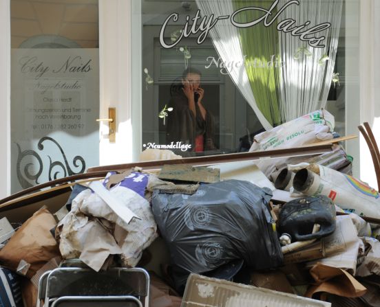 A woman peers out onto the street flooded by the River Danube in Passau, Germany, on June 5.