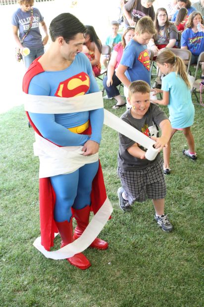Sometimes superduties just involve spreading a little cheer. Resident Superman Josh Boultinghouse takes part in one of the free games for kids held during the Superman Celebration. 