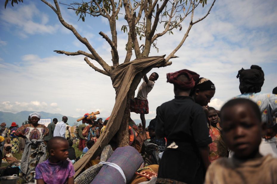 A girl climbs a tree at a displacement camp set up in the North Kivu town of Kiwanja. The Democratic Republic of Congo has seen more than its share of violence over the decades. Civil wars have left millions dead across the country and displaced entire generations.