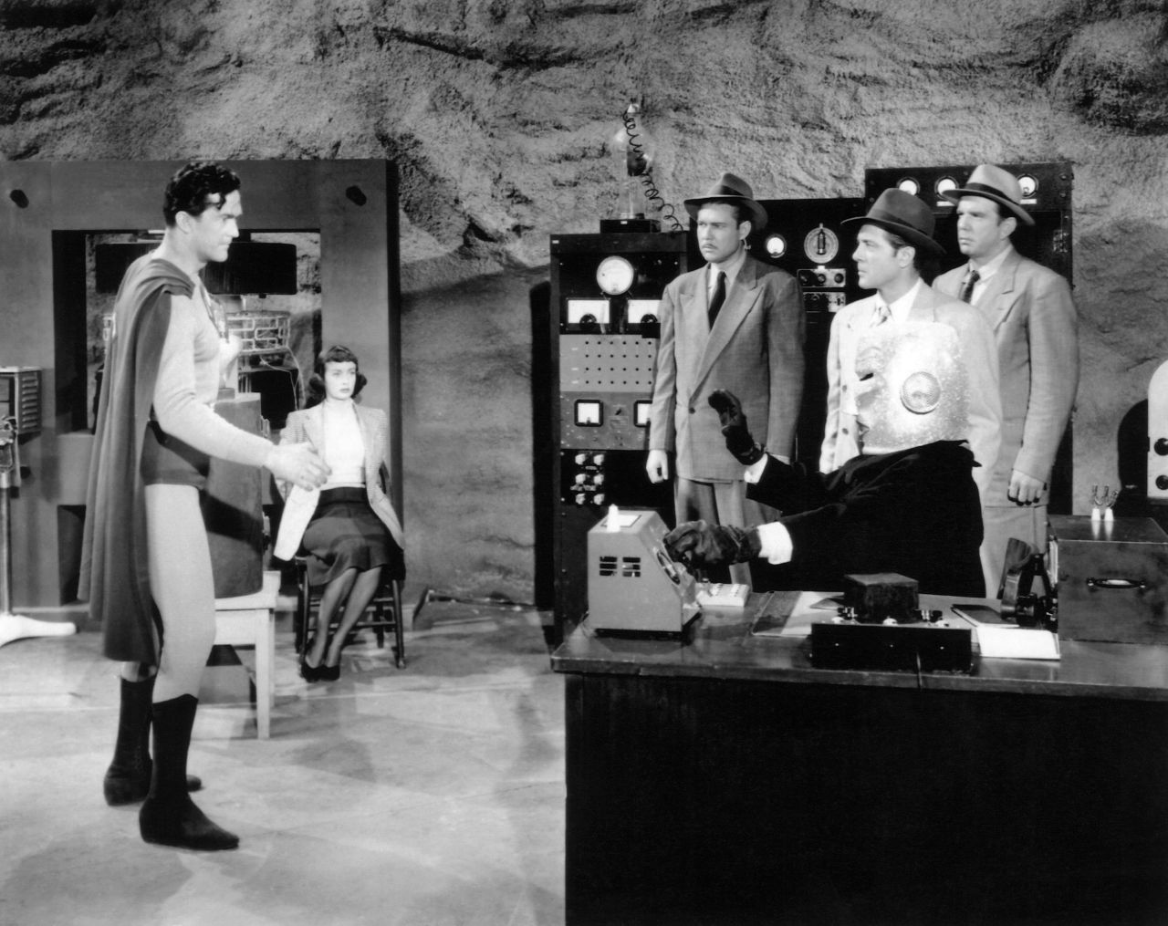 Alyn revisits his role as Superman in the 1950 film serial "Atom Man vs. Superman." Lyle Talbot, seated at right, plays the supervillain Lex Luthor, the Atom Man.