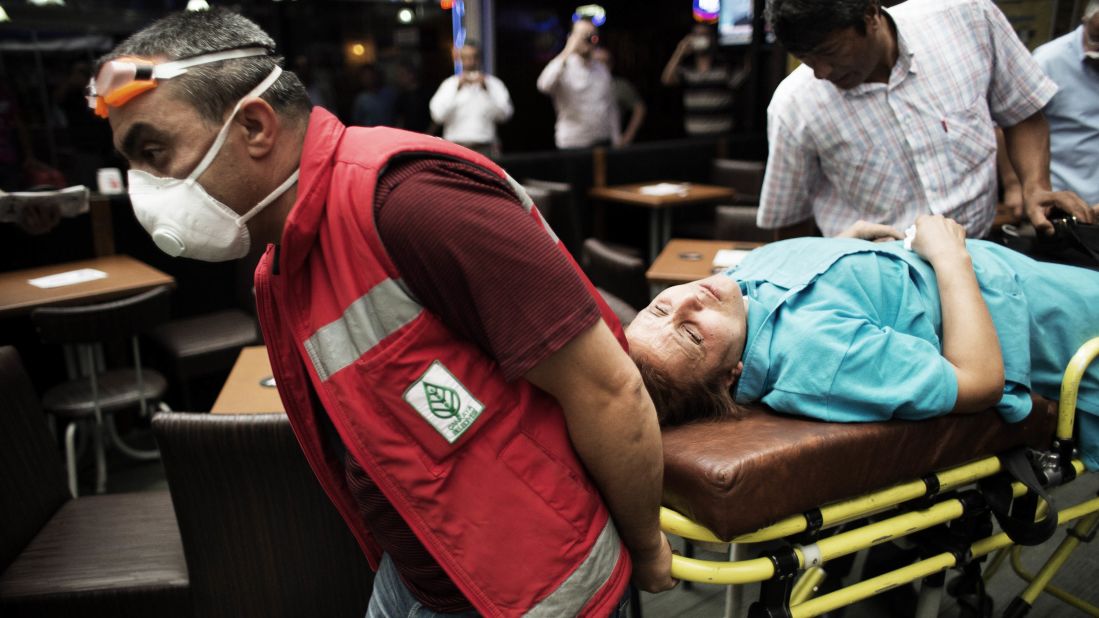 A woman is wheeled away by paramedics during clashes on Kizilay Square in Ankara on Wednesday, June 5.