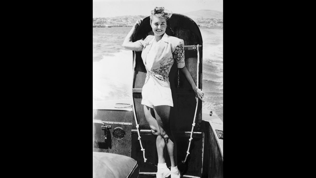 Williams poses with a ironing board before competing in the "Ironing board derby" between Catalina Island and the California coast on August 25, 1947.