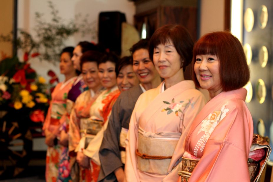 Japanese art teachers show off their colorful kimonos for the exhibition opening. Many younger Japanese Brazilians keep in touch with their heritage by spending several months in their ancestors' homeland, on a Japanese government grant, studying traditional dance, tea ceremony , and ikebana -- the traditional Japanese art of arranging flowers. 