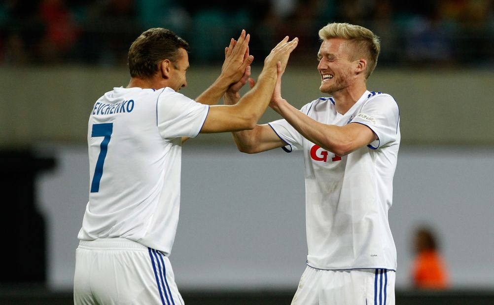Former Ukraine international Andriy Shevchenko, who played with Ballack at Chelsea, and Bayer Leverkusen's Andre Schurrle, who has been linked with a move to London, celebrate the latter's goal in a match that ended 4-3 to the German XI. Ballack scored a hat-trick.