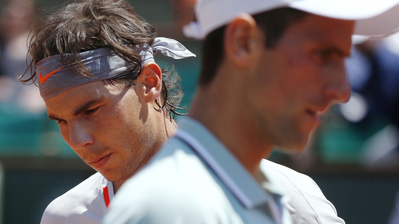 Nadal, left, and Djokovic change sides during their June 7 match.
