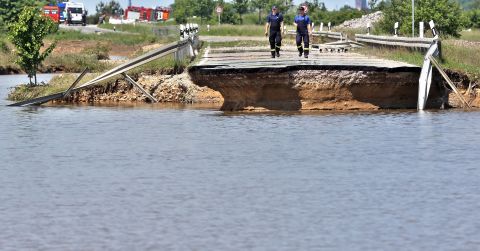 Members of the emergency services inspect a road washed away by flood water near Loebnitz, eastern Germany, on June 7.
