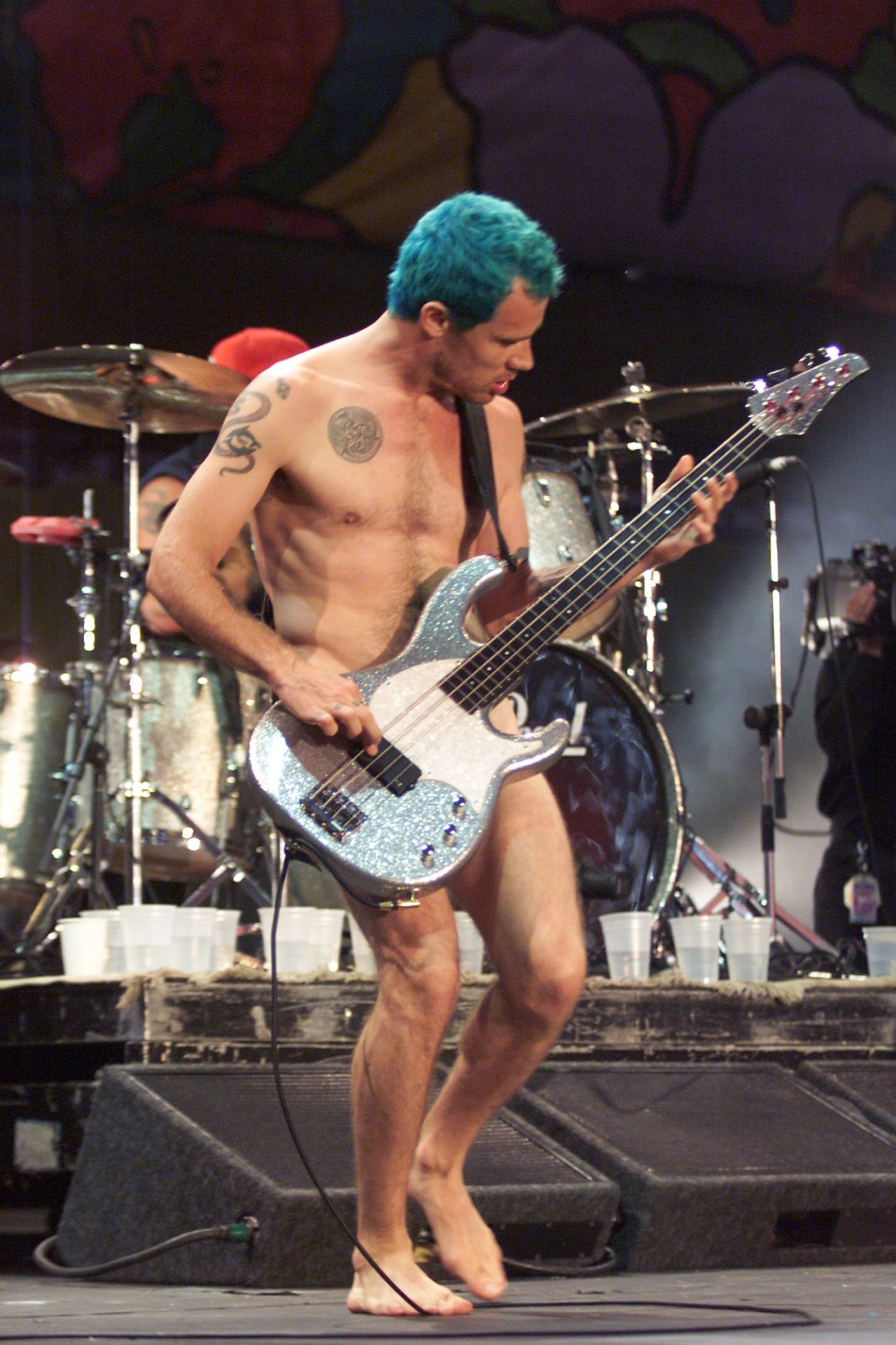 Red Hot Chili Peppers bassist Flea, whose real name is Michael Balzary, performs nude at Woodstock '99, a summer musical held in Rome, New York, as a tribute to its 1969 namesake.