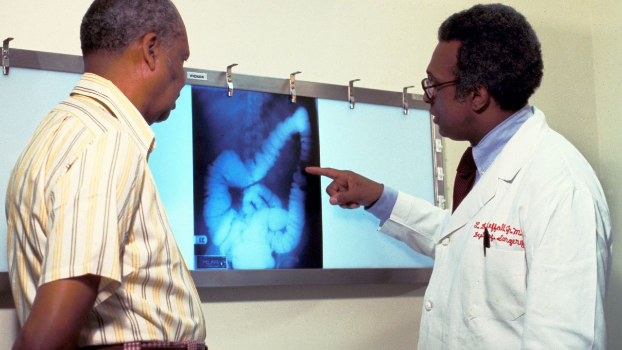 A doctor goes over a patient''s x-ray, screening for colon cancer. There is no single cause of colon cancer. Cancer of the colon and rectum s for 15% of cancer deaths.