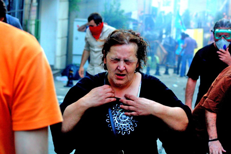 Police have used tear gas, or pepper spray, at some demonstrations. iReporter <a href="http://ireport.cnn.com/docs/DOC-981786">Görkem Keser </a>captured this image of a woman suffering effects of the gas.