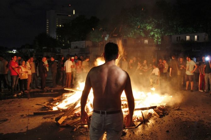Another image by <a href="index.php?page=&url=http%3A%2F%2Fireport.cnn.com%2Fdocs%2FDOC-982924">Nate Hovee</a> shows a shirtless protester in Istanbul late Sunday evening