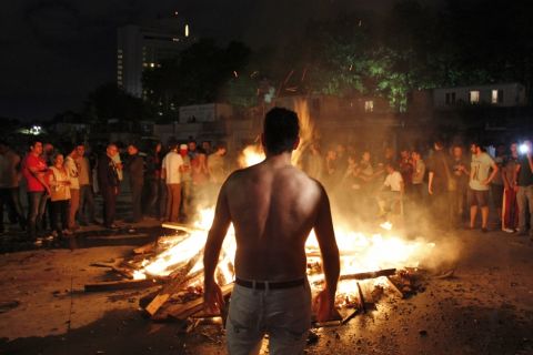 Another image by <a href="http://ireport.cnn.com/docs/DOC-982924">Nate Hovee</a> shows a shirtless protester in Istanbul late Sunday evening
