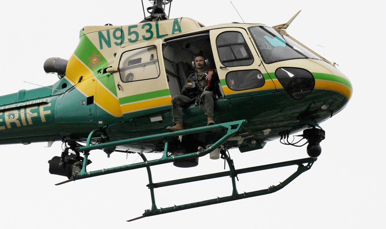  A Los Angeles County SWAT team sharpshooter circles the campus in a helicopter.