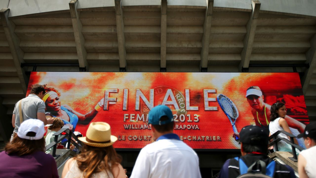 Tennis fans watch the big screen outside Court Suzanne Lenglen in Paris before the match between Williams and Sharapova.