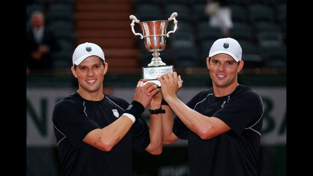   Bob Bryan and Mike Bryan pose with the trophy after winning the men's doubles final against Michael Llorda and Nicolas Mahut of France on June 8. The twins won 6-4, 4-6, 7-6(4).