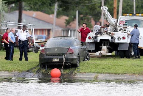 A tow truck pulls a car, identified as belonging to missing teacher, Terrilynn Monette, from Bayou St. John near the Harrison Avenue bridge in New Orleans, Louisiana, on Saturday, June 8, 2013. Monnette has been missing since she disappeared on March 2.
