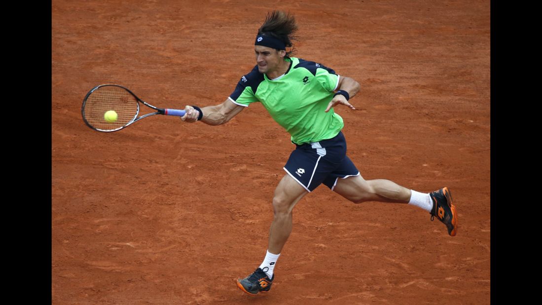Ferrer returns a shot to Nadal.