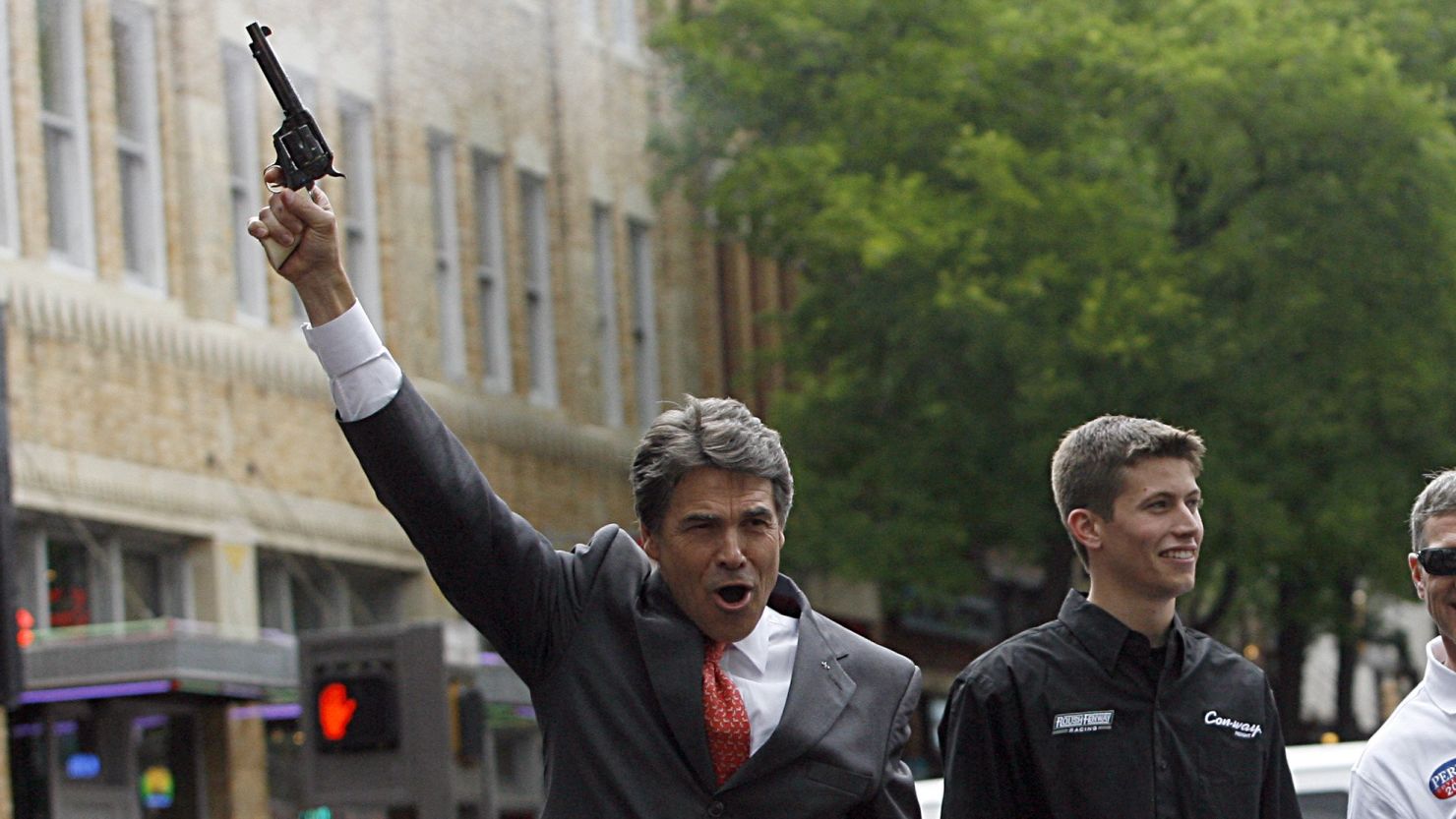 Texas Gov. Rick Perry fires a six-shooter.  