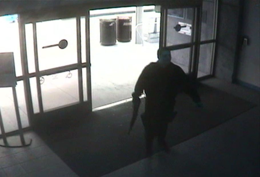 The gunman enters the college library wearing black fatigues.