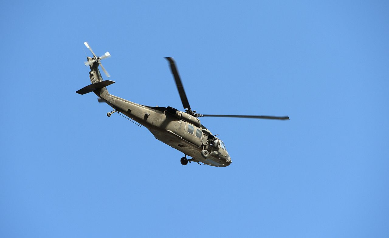 A U.S. military helicopter flies over the Kabul airport as fighting ensues between Afghan security forces and insurgents on June 10.